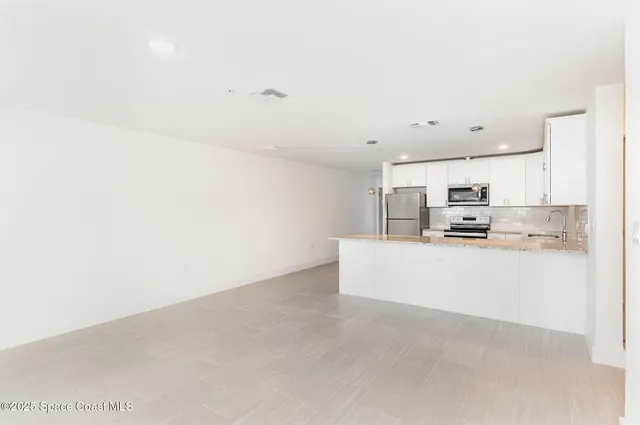 a view of kitchen with stainless steel appliances