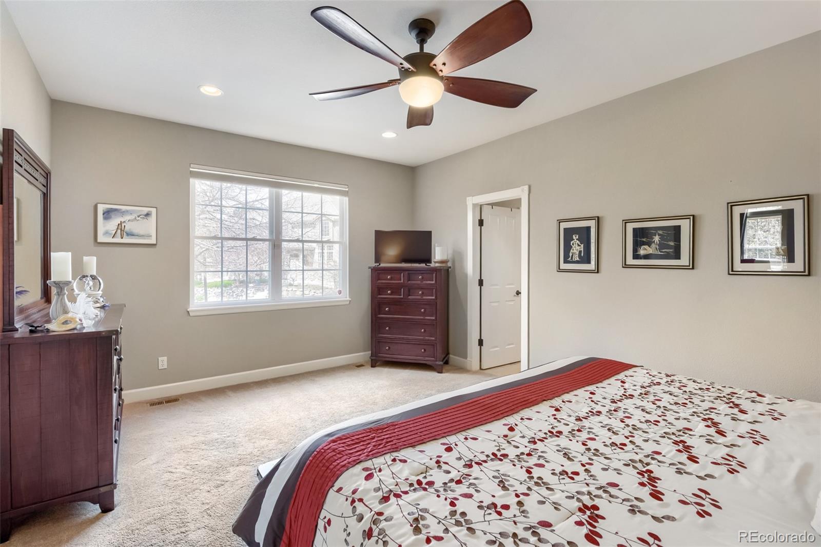 9006 Old Tom Morris Circle Highlands Ranch, CO 80129 - Photo 15 of 41 a bedroom with a large bed and a window