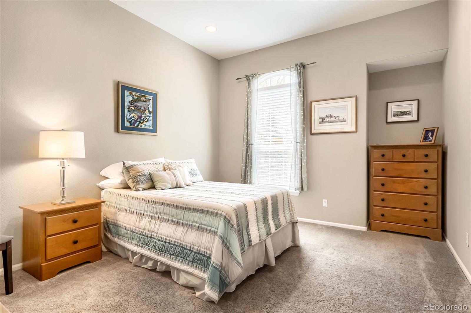9006 Old Tom Morris Circle Highlands Ranch, CO 80129 - Photo 19 of 41 a bedroom with a bed and a night stand