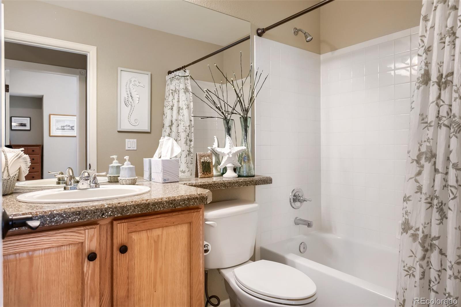 9006 Old Tom Morris Circle Highlands Ranch, CO 80129 - Photo 20 of 41 a bathroom with a granite countertop sink a toilet and shower