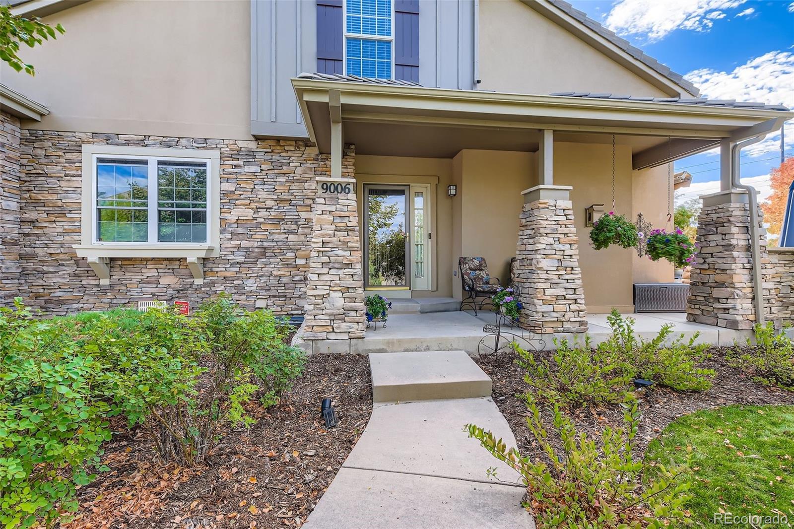 9006 Old Tom Morris Circle Highlands Ranch, CO 80129 - Photo 2 of 41 a front view of a house with a garden