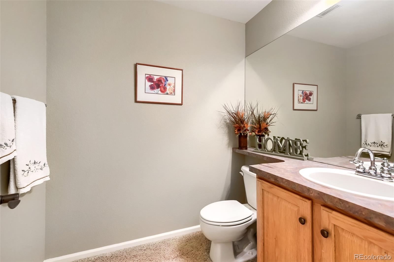 9006 Old Tom Morris Circle Highlands Ranch, CO 80129 - Photo 24 of 41 a bathroom with a sink mirror vanity and toilet