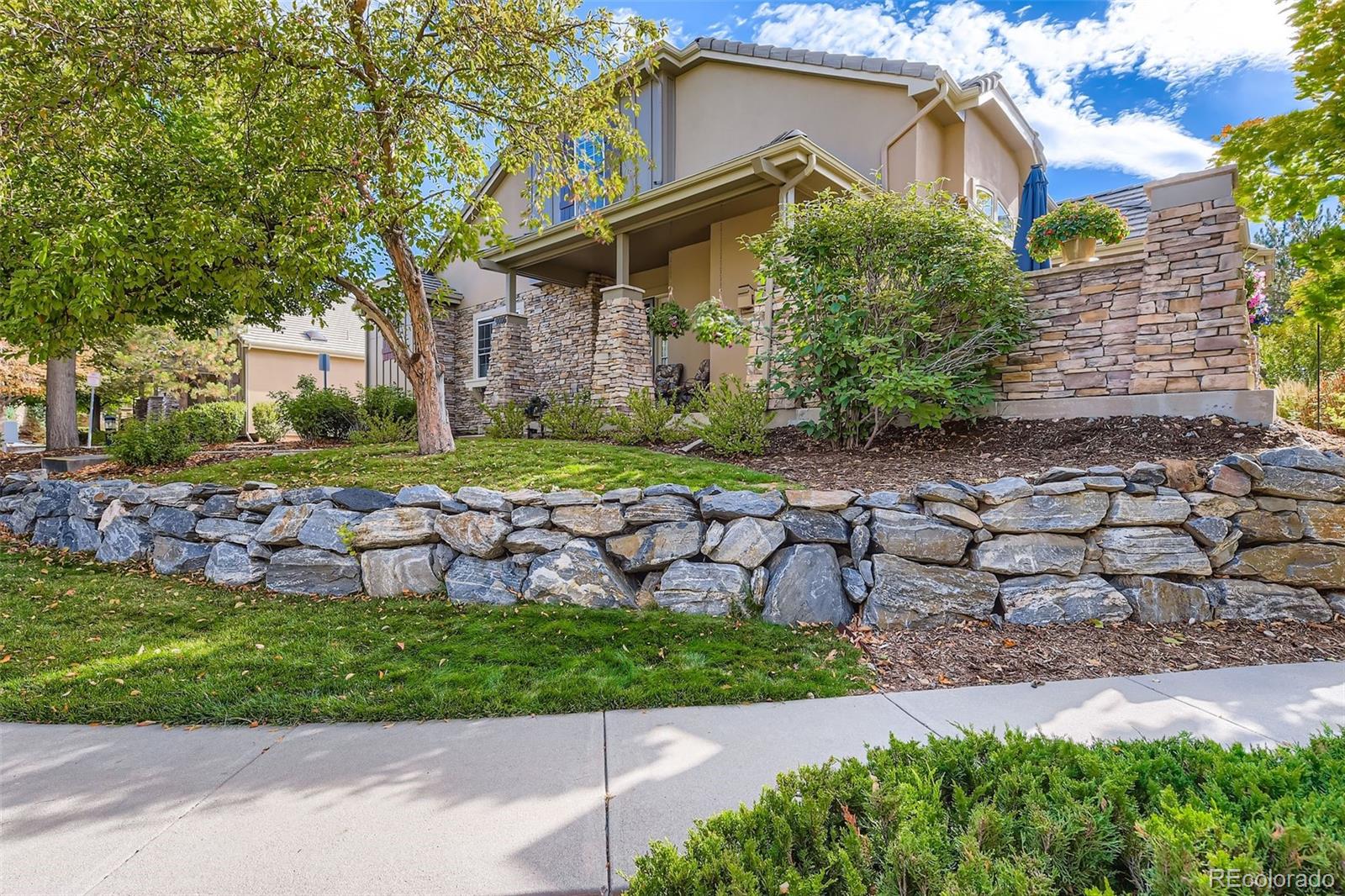 9006 Old Tom Morris Circle Highlands Ranch, CO 80129 - Photo 3 of 41 a front view of a house with a yard
