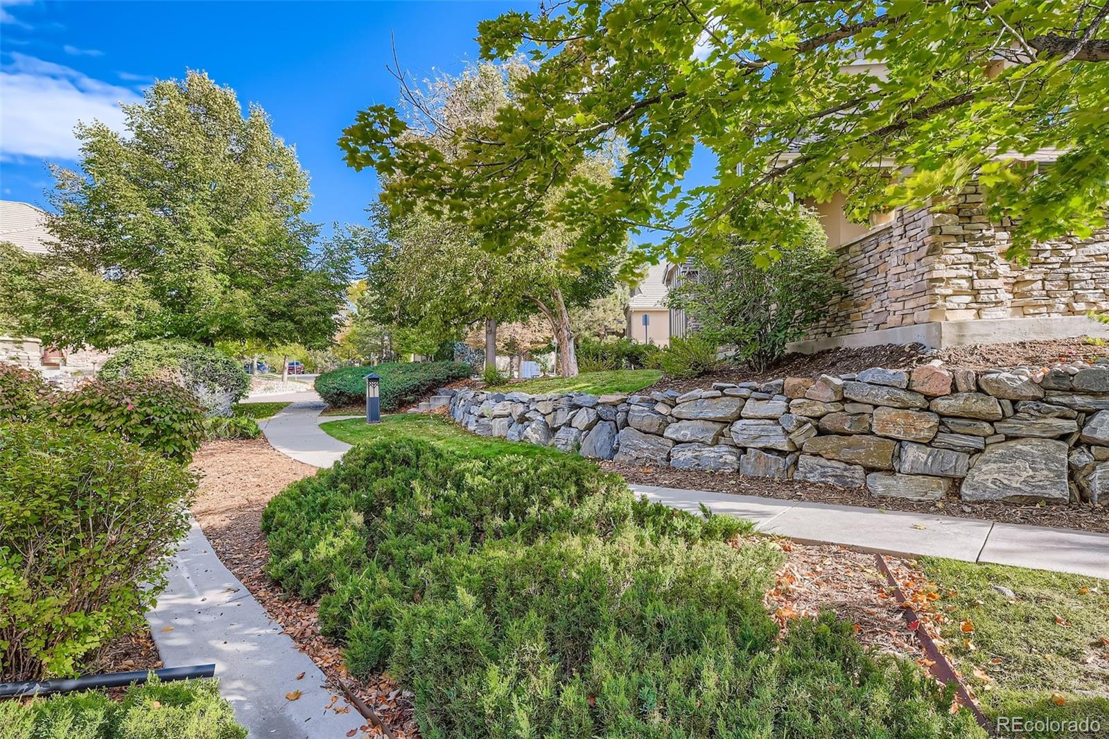 9006 Old Tom Morris Circle Highlands Ranch, CO 80129 - Photo 32 of 41 a view of a street with a bench
