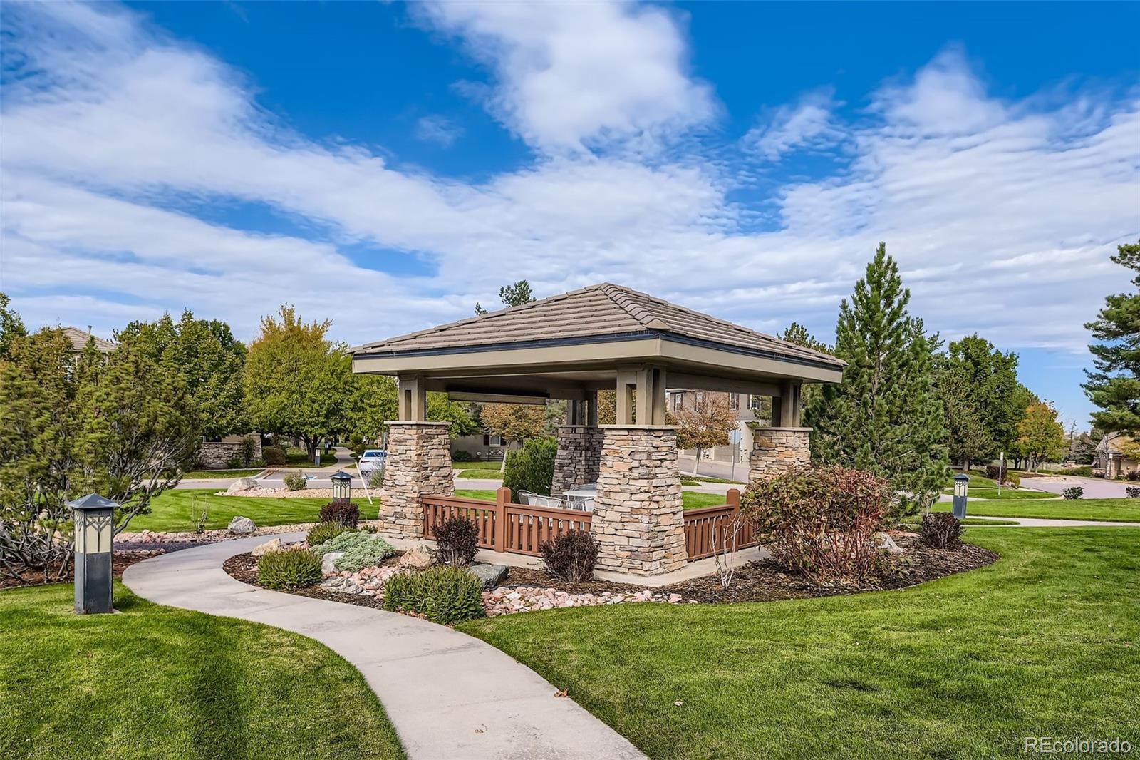 9006 Old Tom Morris Circle Highlands Ranch, CO 80129 - Photo 37 of 41 a front view of a house with garden