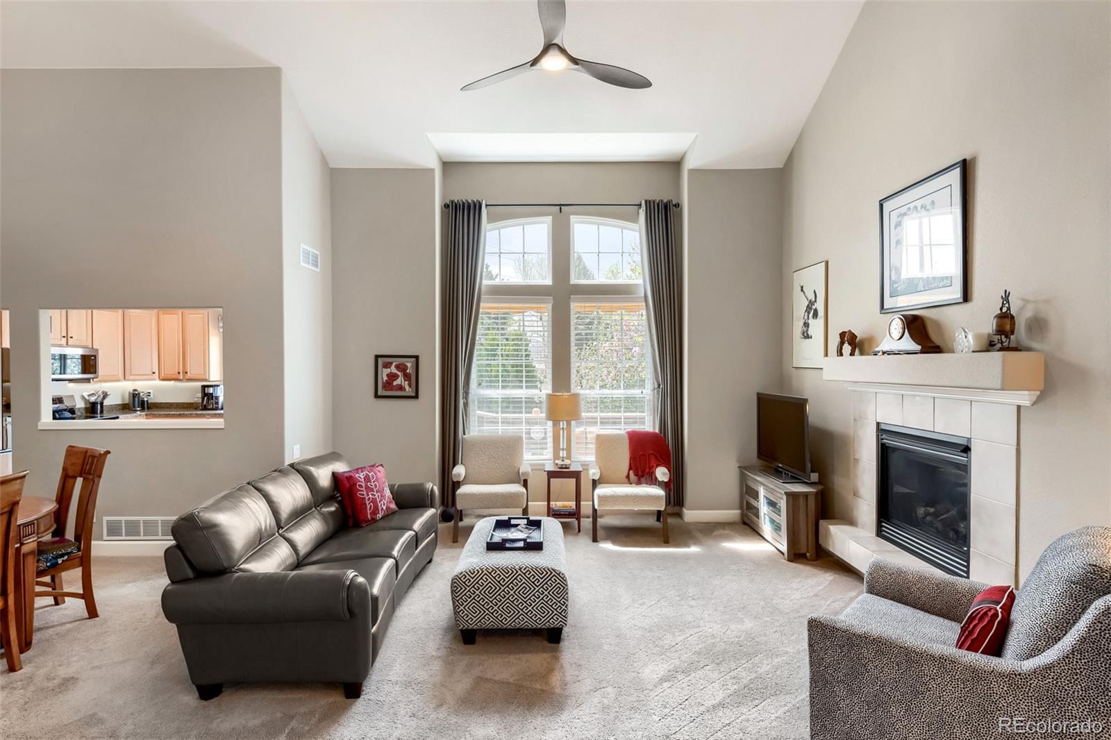 9006 Old Tom Morris Circle Highlands Ranch, CO 80129 - Photo 5 of 41 a living room with furniture and a fireplace