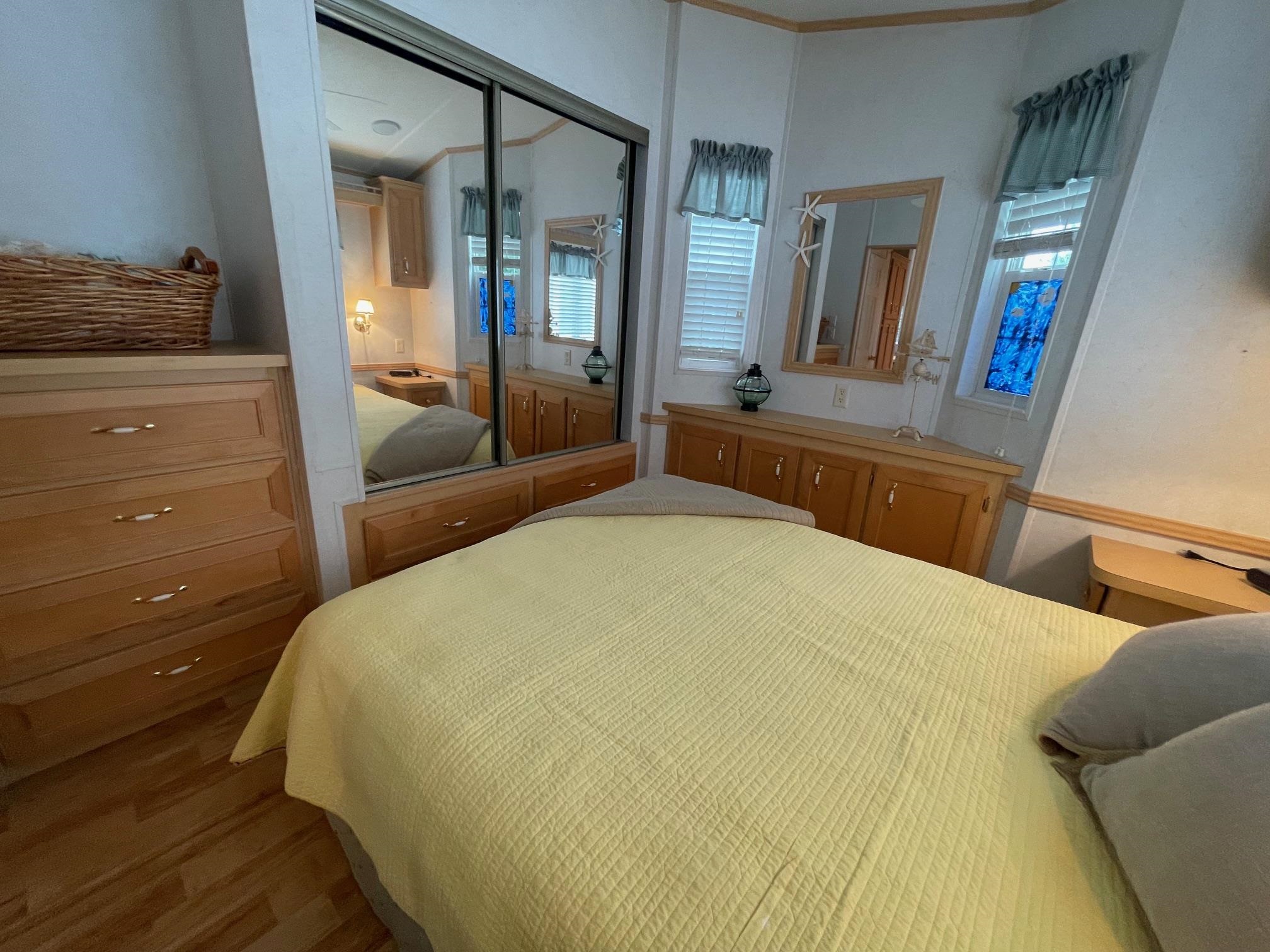 4100 Rte 9 South, Unit 9 Rio Grande, NJ 08242 - Photo 16 of 31 a bedroom with a bed and large mirror on dresser
