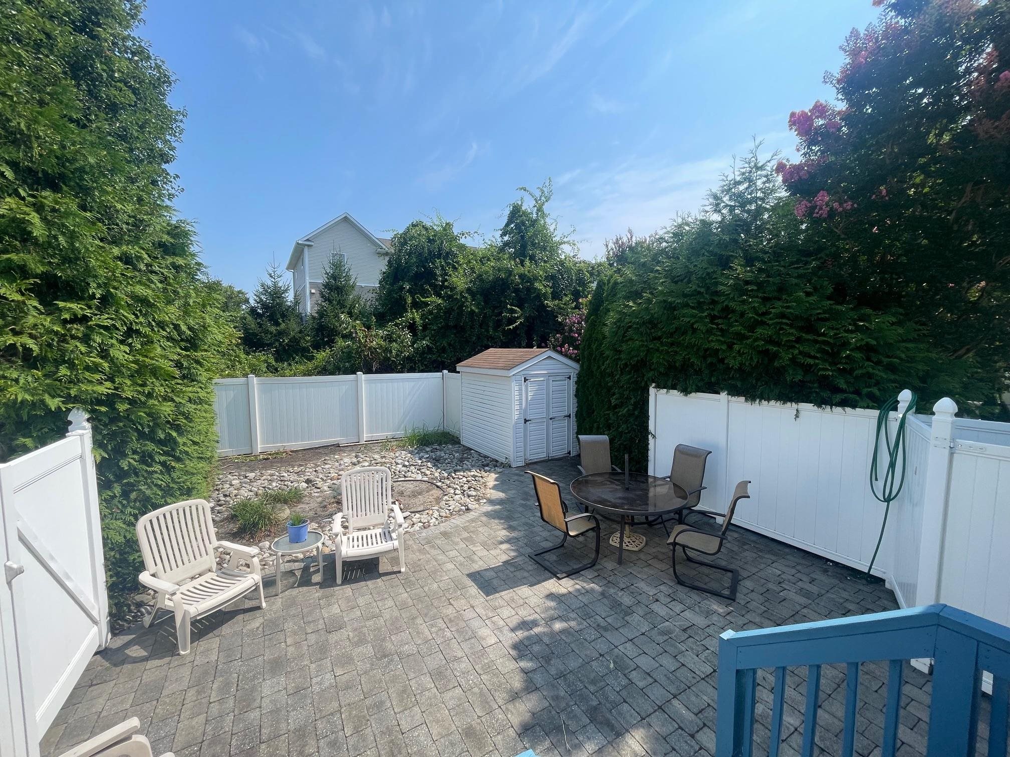 4100 Rte 9 South, Unit 9 Rio Grande, NJ 08242 - Photo 24 of 31 a backyard of a house with table and chairs