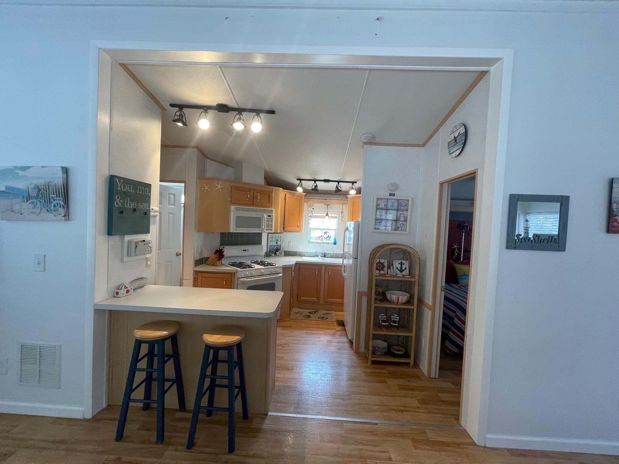 4100 Rte 9 South, Unit 9 Rio Grande, NJ 08242 - Photo 10 of 31 a view of a kitchen with dining table and chairs