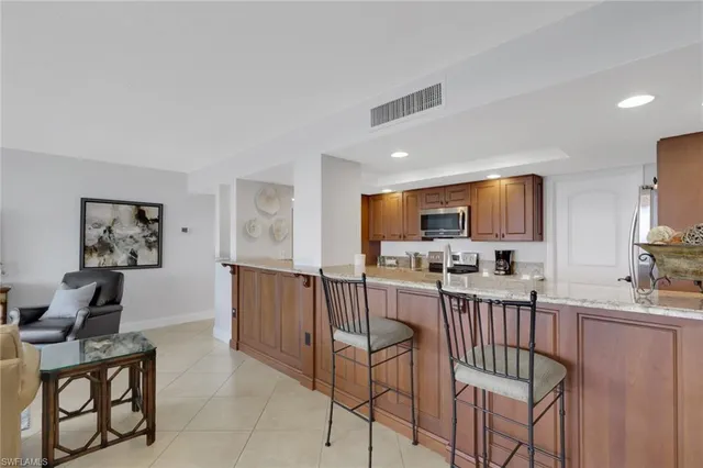 a living room with furniture and floor to ceiling window