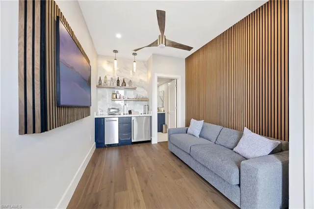 a living room with furniture and kitchen view