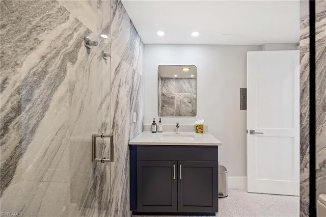 a bathroom with a sink a mirror and a shower