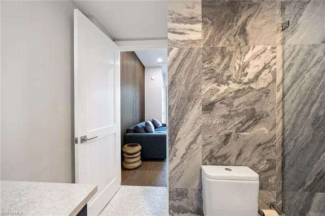 a bathroom with a toilet and a shower curtain