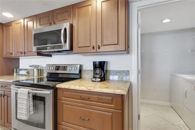 a kitchen with stainless steel appliances granite countertop a stove a microwave and cabinets