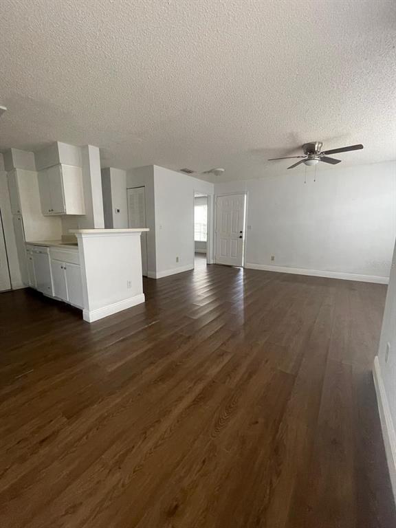 1089 South Hiawassee Road, Unit 313 Orlando, FL 32835 - Photo 3 of 10 a view of a room with wooden floor and a cabinet