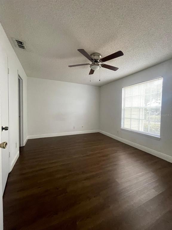 1089 South Hiawassee Road, Unit 313 Orlando, FL 32835 - Photo 4 of 10 a view of empty room with wooden floor and fan