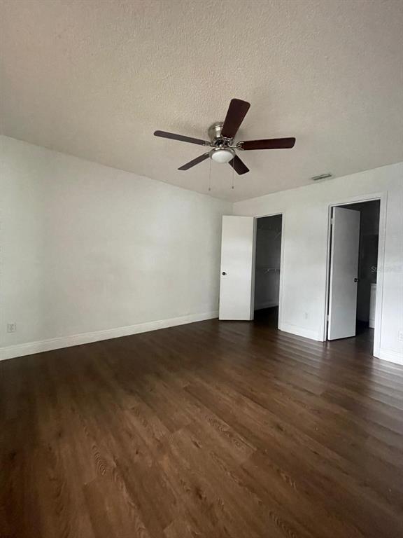 1089 South Hiawassee Road, Unit 313 Orlando, FL 32835 - Photo 5 of 10 a view of an empty room with wooden floor and a ceiling fan