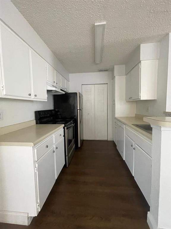 1089 South Hiawassee Road, Unit 313 Orlando, FL 32835 - Photo 8 of 10 a kitchen with granite countertop white cabinets and stainless steel appliances