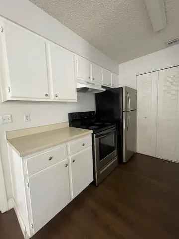 a kitchen with a sink and a refrigerator