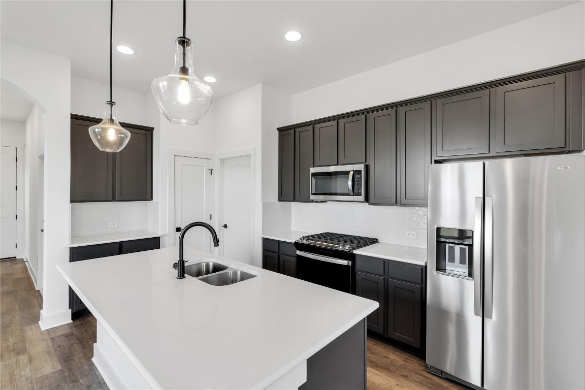 8589 Meridy Loop Round Rock, TX 78665 - Photo 14 of 36 a kitchen with stainless steel appliances a refrigerator sink and stove
