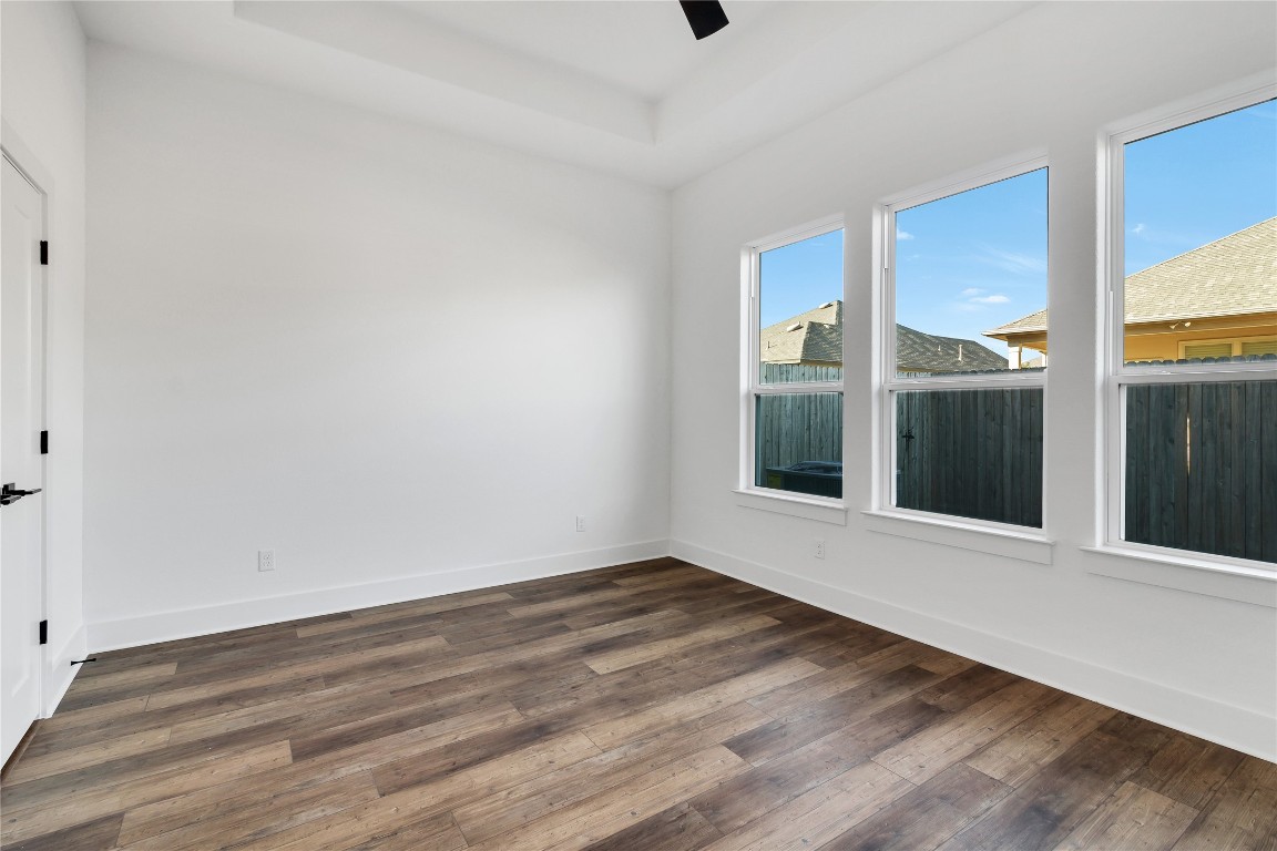 8589 Meridy Loop Round Rock, TX 78665 - Photo 20 of 36 a view of an empty room with wooden floor and a window