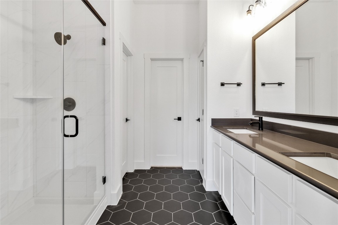 8589 Meridy Loop Round Rock, TX 78665 - Photo 21 of 36 a bathroom with a double vanity sink and mirror