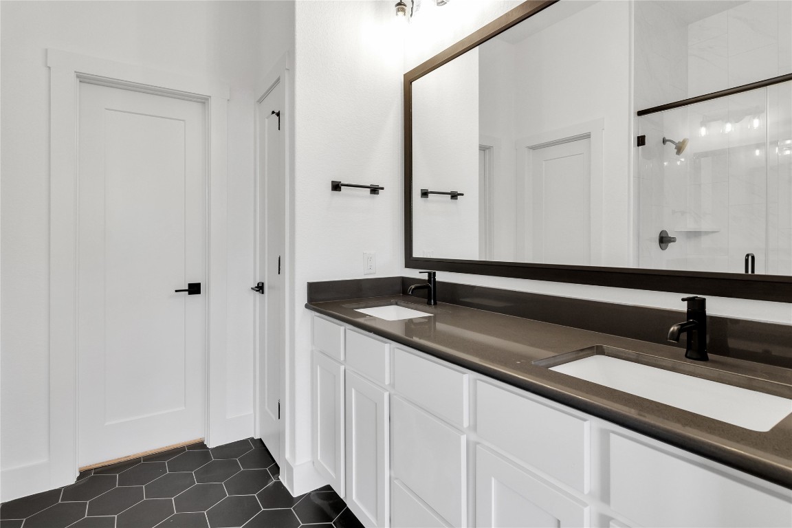 8589 Meridy Loop Round Rock, TX 78665 - Photo 22 of 36 a bathroom with a double vanity sink and a mirror