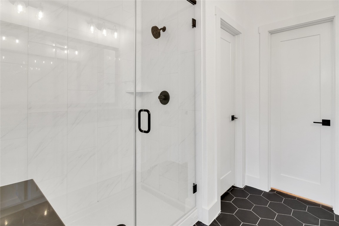 8589 Meridy Loop Round Rock, TX 78665 - Photo 23 of 36 a bathroom with a glass shower door