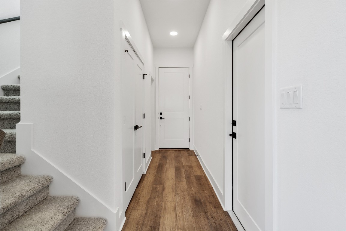 8589 Meridy Loop Round Rock, TX 78665 - Photo 7 of 36 a view of a hallway with wooden floor and staircase