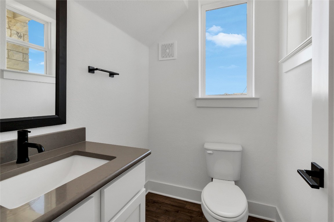 8589 Meridy Loop Round Rock, TX 78665 - Photo 9 of 36 a bathroom with a toilet sink and mirror