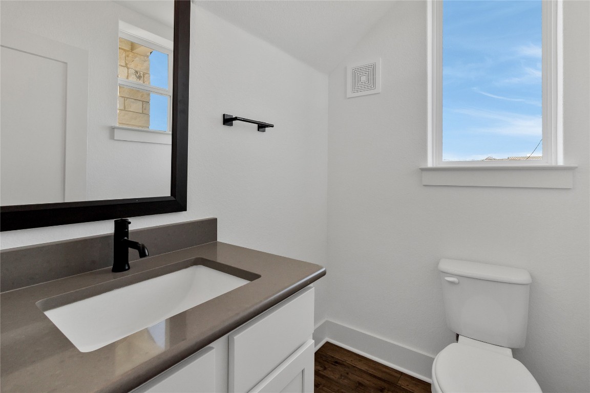 8589 Meridy Loop Round Rock, TX 78665 - Photo 10 of 36 a bathroom with a toilet sink and mirror