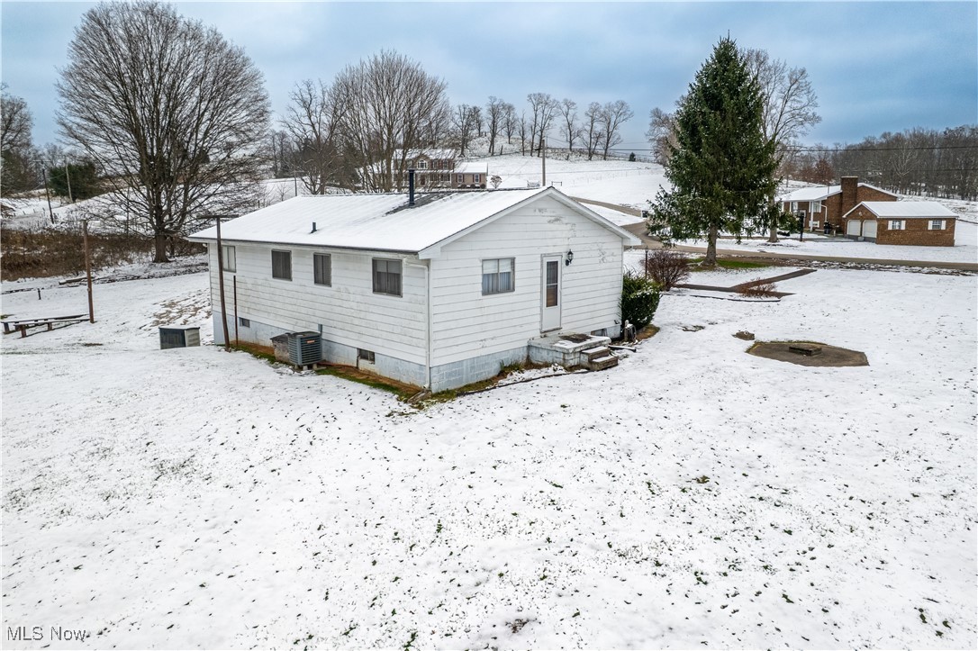 1329 Oak Grove Road Waverly, WV 26184 - Photo 23 of 29 Snow covered house with crawl space