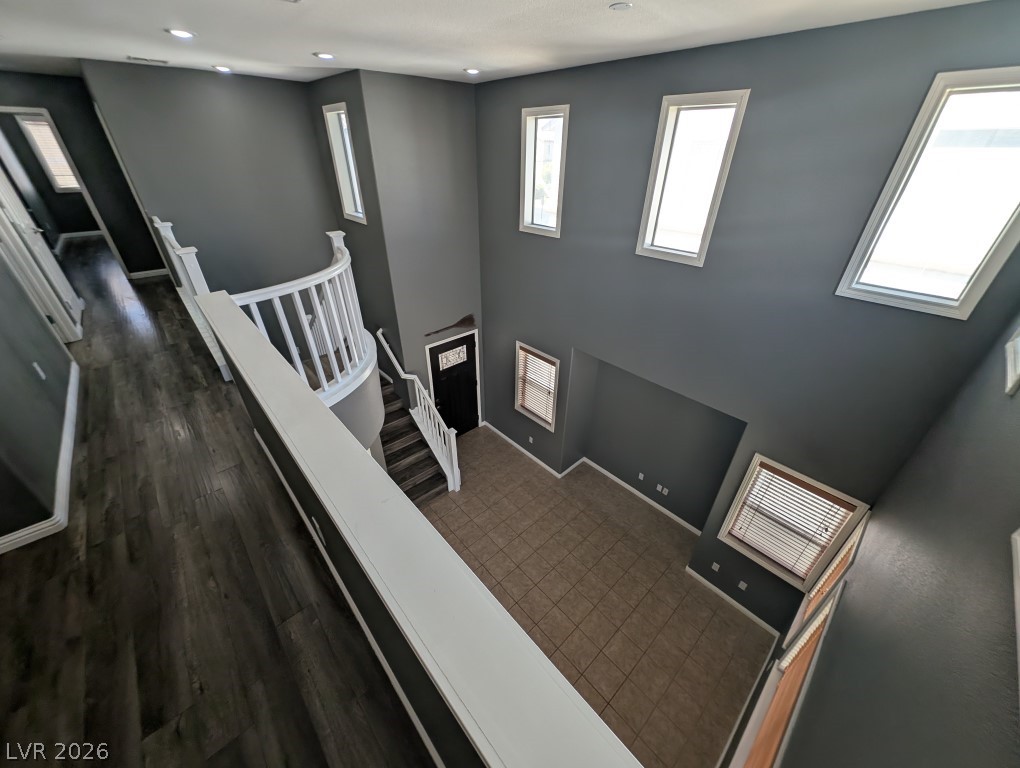9121 Spoonbill Ridge Place Las Vegas, NV 89143 - Photo 9 of 26 A grand, high-ceilinged entrance with a graceful curved staircase and an abundance of natural light.