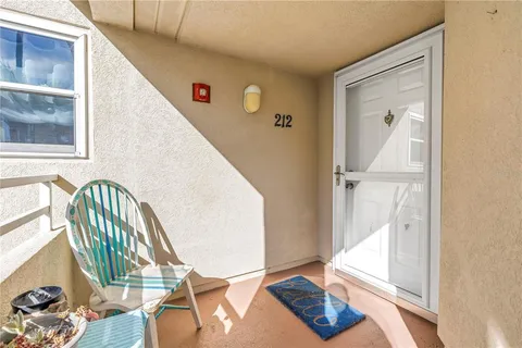 a view of a hallway with wooden floor and windows