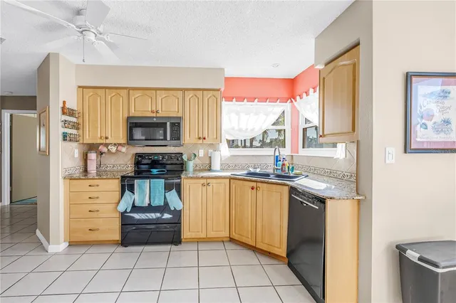 a kitchen with stainless steel appliances a stove sink and microwave
