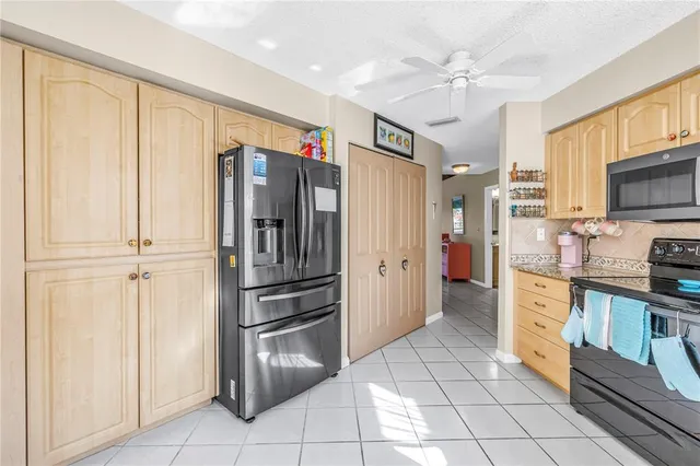 a kitchen with stainless steel appliances a refrigerator and microwave