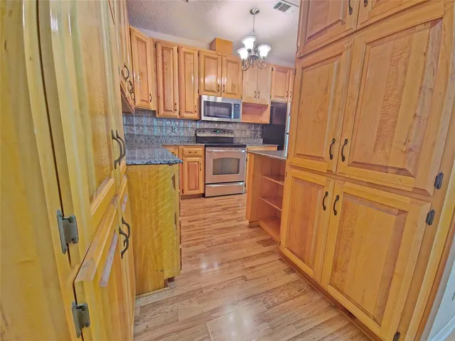 a kitchen with stainless steel appliances a refrigerator and cabinets