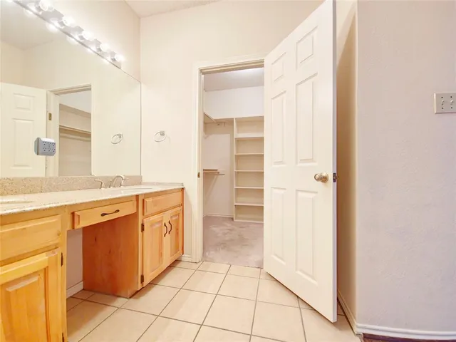 a bathroom with a sink a mirror and a shower