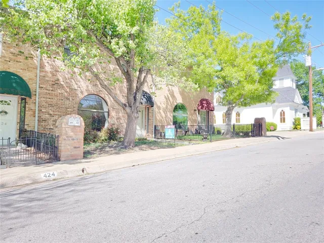 a view of a street with houses on both side