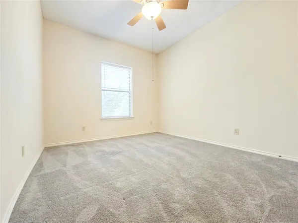 an empty room with a empty space and a ceiling fan