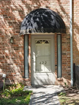 a view of a house with a small yard and plants