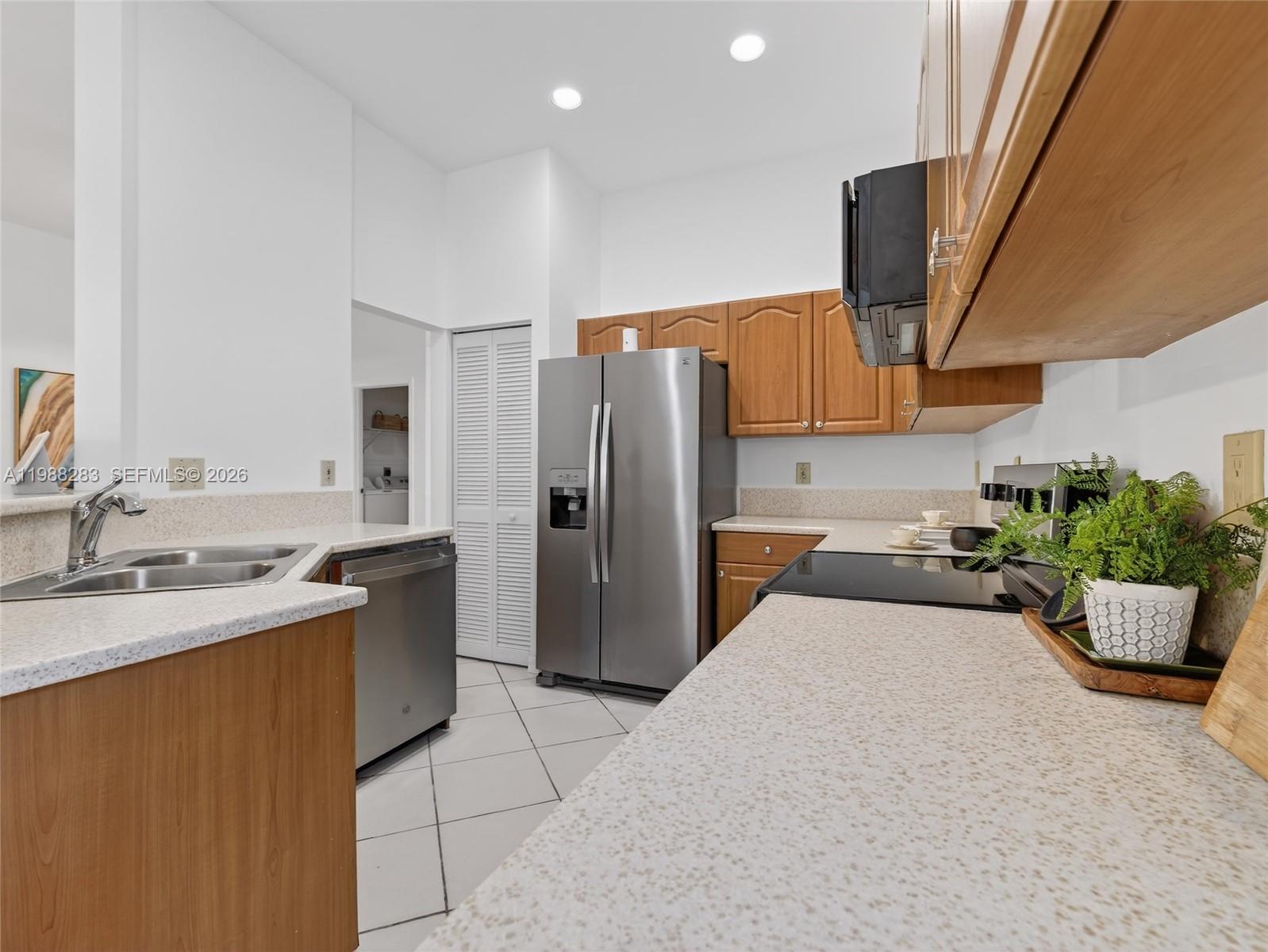 4317 Willow Ridge Drive Weston, FL 33331 - Photo 11 of 71 a kitchen with a refrigerator and a sink