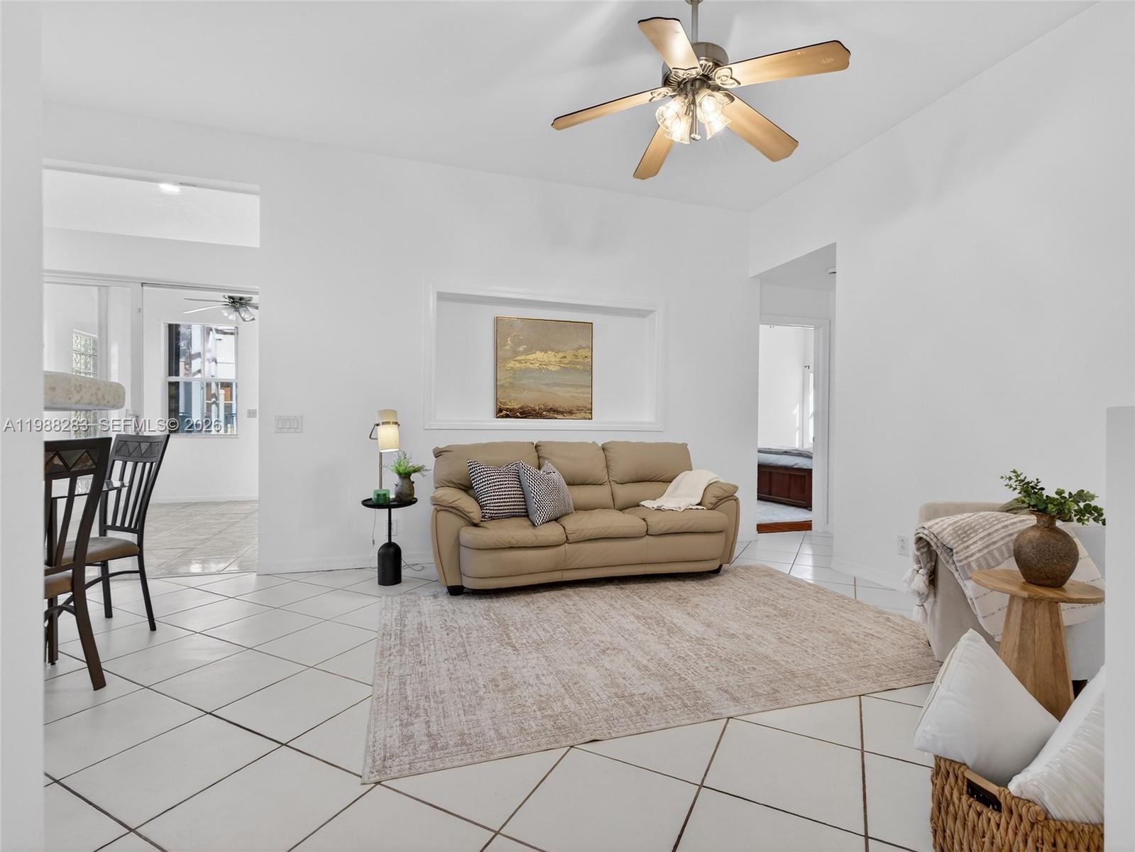 4317 Willow Ridge Drive Weston, FL 33331 - Photo 13 of 71 a living room with furniture and a chandelier