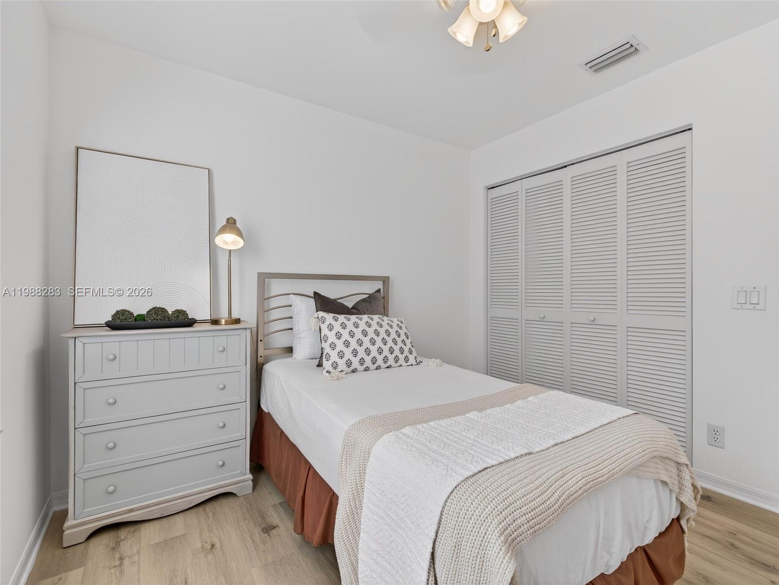 4317 Willow Ridge Drive Weston, FL 33331 - Photo 25 of 71 a bedroom with a bed and a chandelier fan