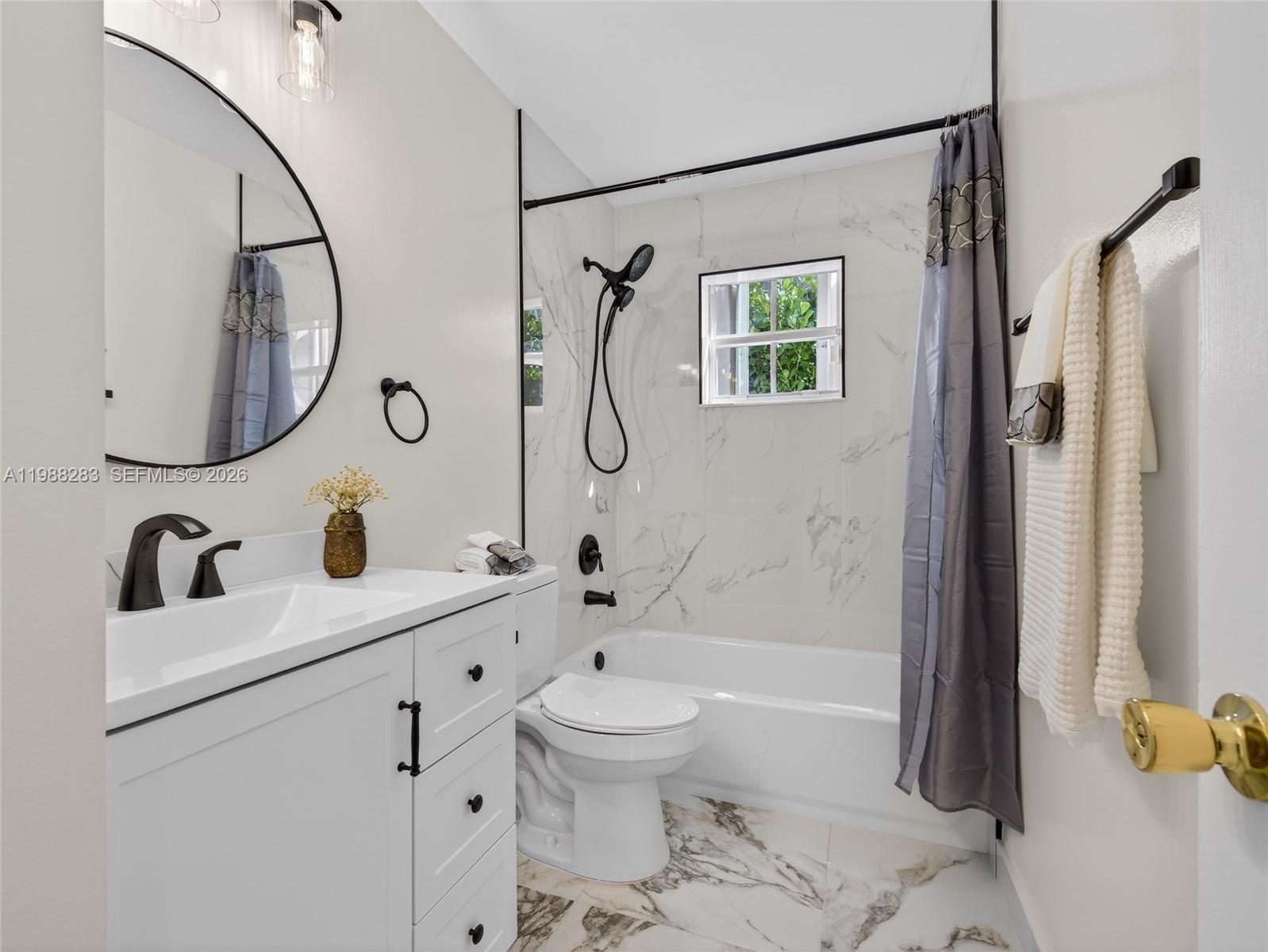 4317 Willow Ridge Drive Weston, FL 33331 - Photo 26 of 71 a bathroom with a sink a toilet and a mirror