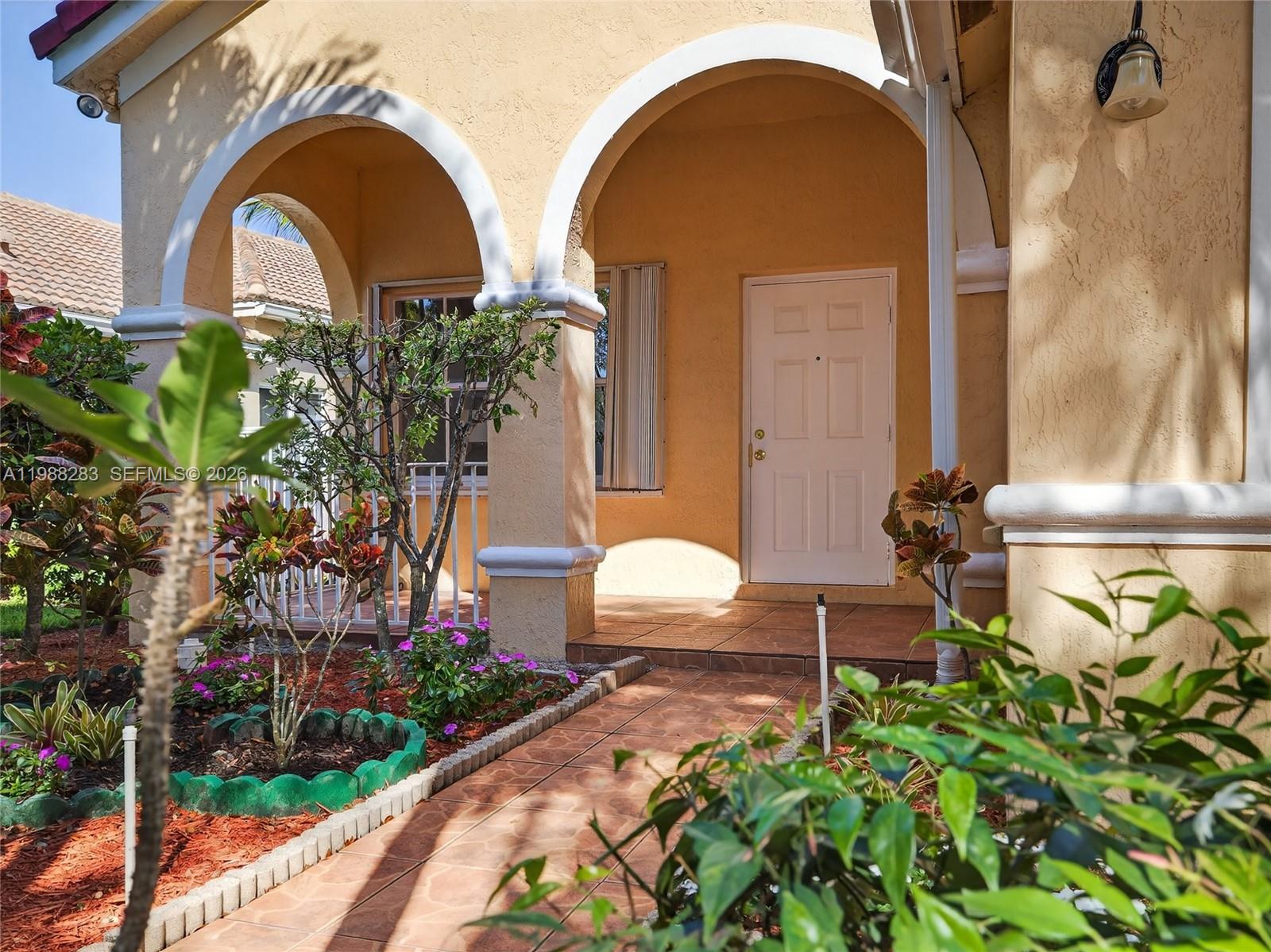 4317 Willow Ridge Drive Weston, FL 33331 - Photo 47 of 71 a front view of a house with a yard