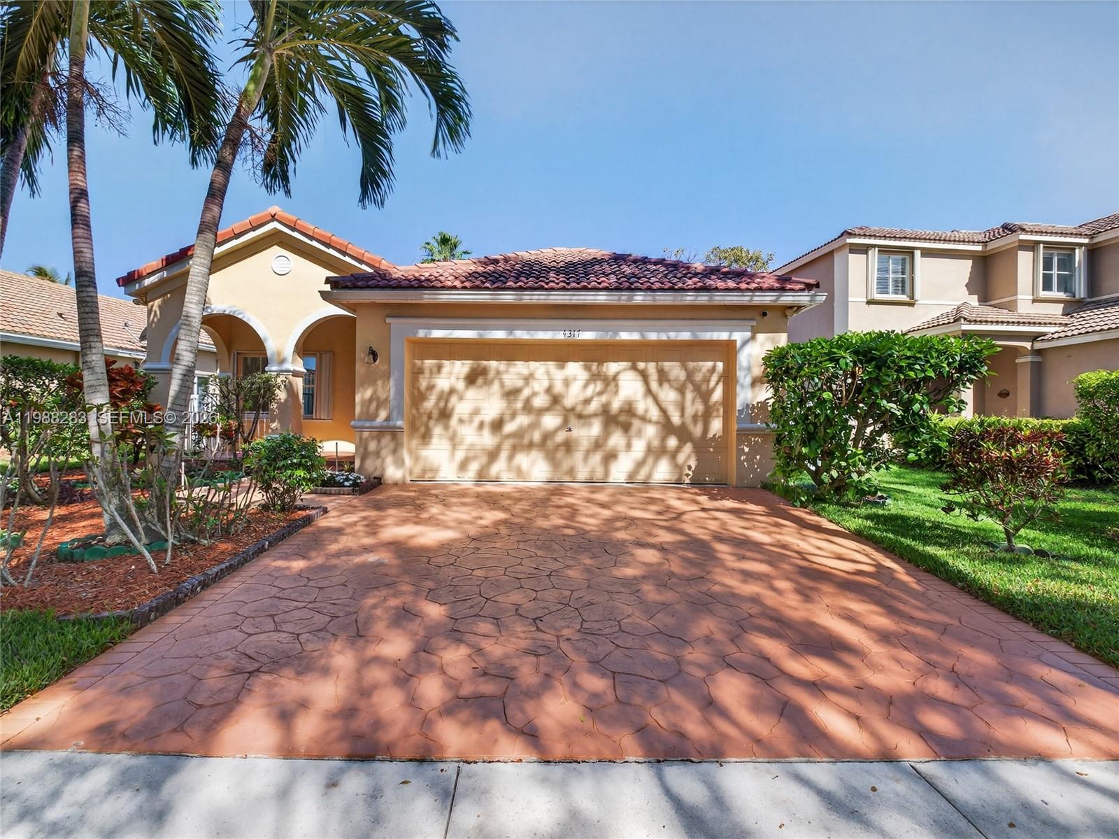 4317 Willow Ridge Drive Weston, FL 33331 - Photo 48 of 71 a view of a house with a yard and potted plants