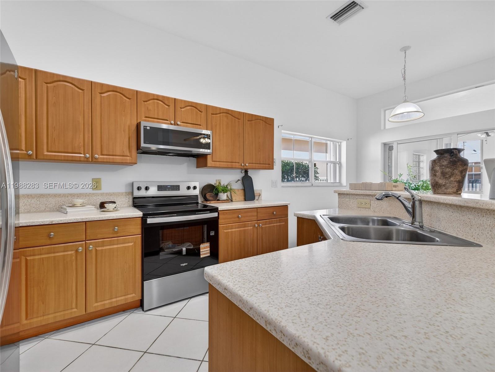 4317 Willow Ridge Drive Weston, FL 33331 - Photo 9 of 71 a kitchen with stainless steel appliances granite countertop a sink counter space cabinets and a sink