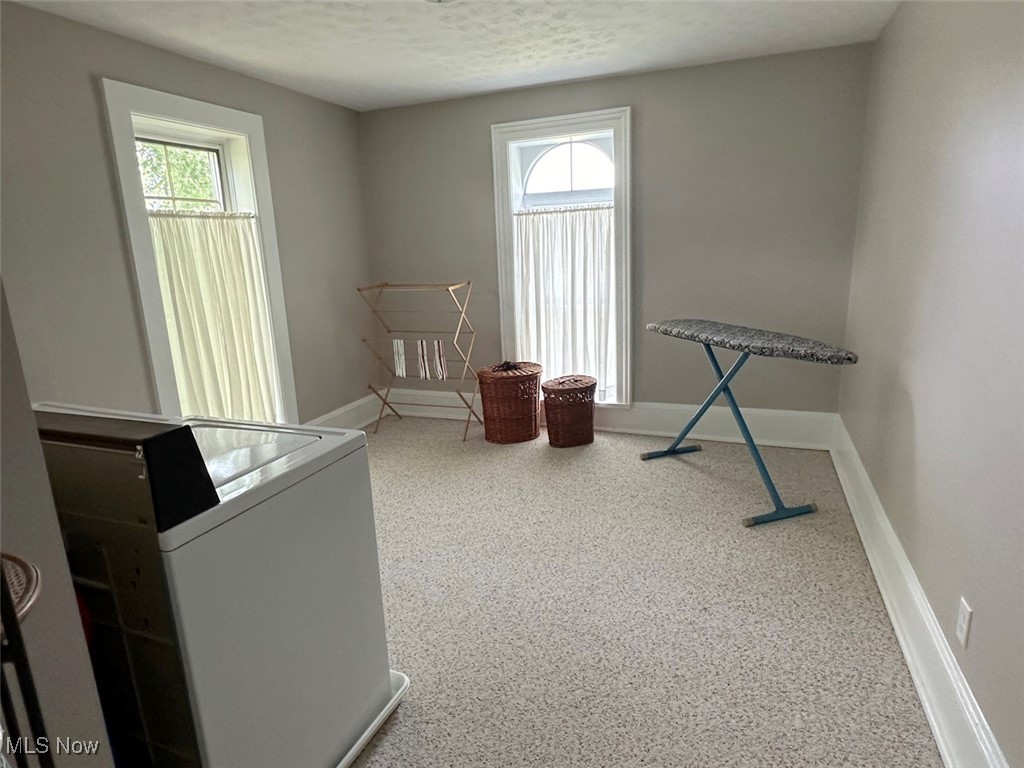 1241 Apollo Road Southeast Carrollton, OH 44615 - Photo 30 of 33 Misc room with a textured ceiling, washer / clothes dryer, and a wealth of natural light