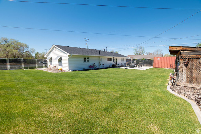 340 West 100 N Street Beaver, UT 84713 - Photo 29 of 37 Expansive backyard featuring a lush lawn, concrete patio, and a dedicated storage shed